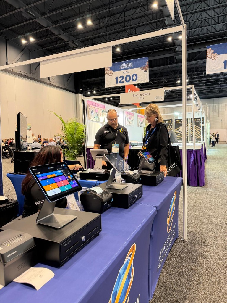 A live Jewelers Flow demo at the Atlanta Jewelry Show, with an iPad register and thermal printer on the counter