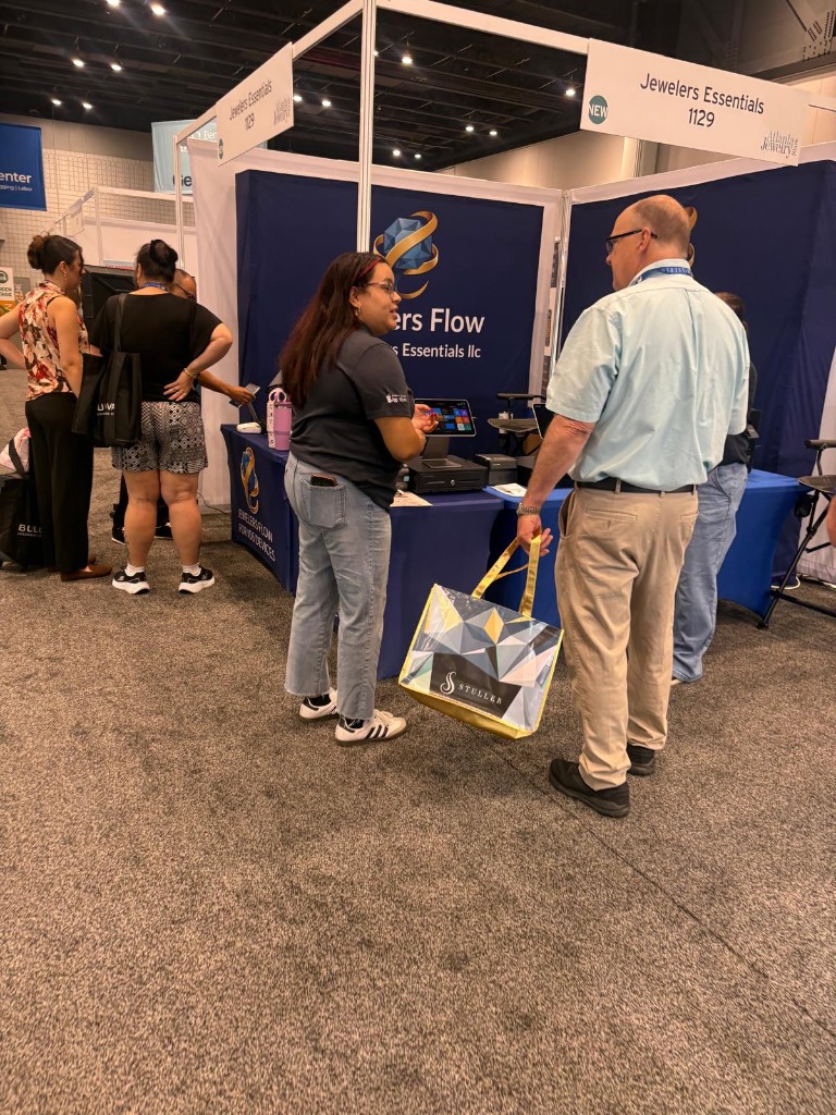 A jewelry-show attendee visiting the Jewelers Flow booth at Atlanta Jewelry Show
