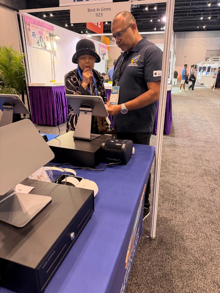 A Jewelers Flow exhibitor walking a retailer through the app at Atlanta Jewelry Show